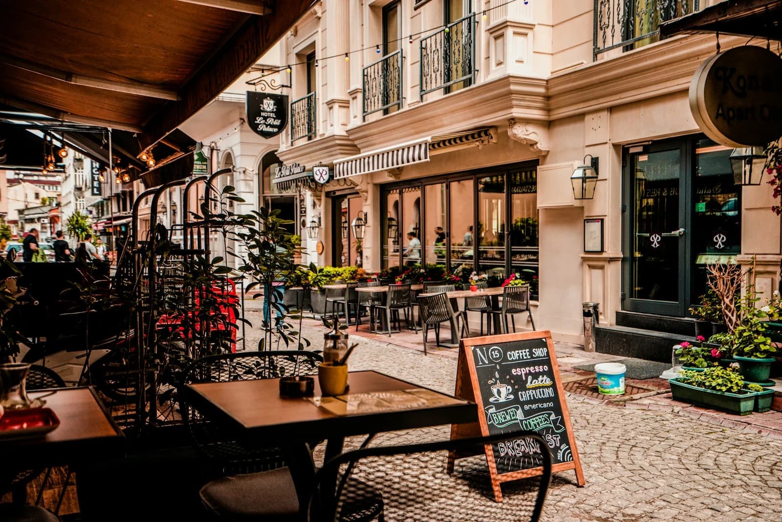 Warm cobblestone street terrace with ambient outdoor seating in the evening